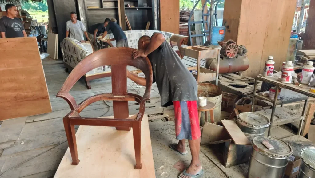 Experienced carpenter crafting custom teak furniture in Bali